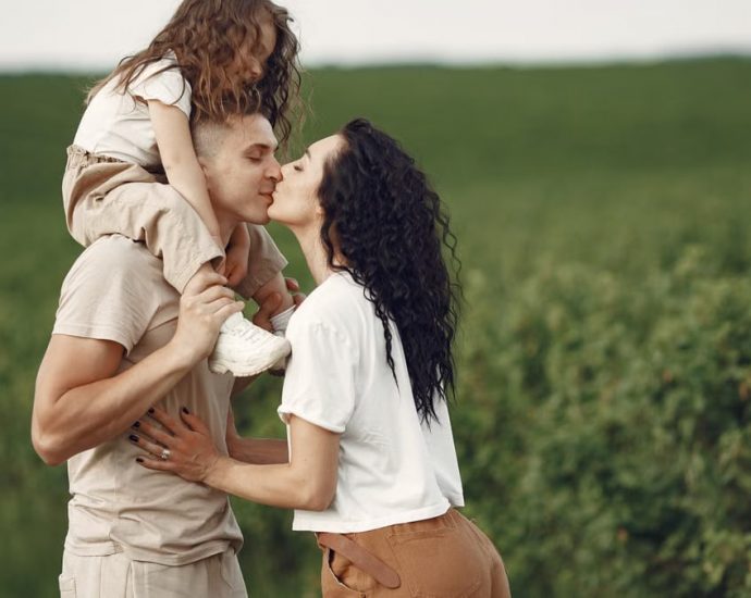 A heartwarming family moment captured in a field, highlighting love and togetherness.